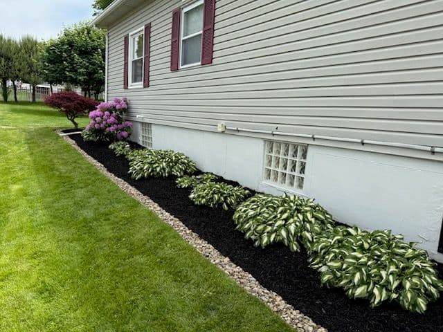 Stunning Garden Update with Mulch Bed and River Rock Finish image