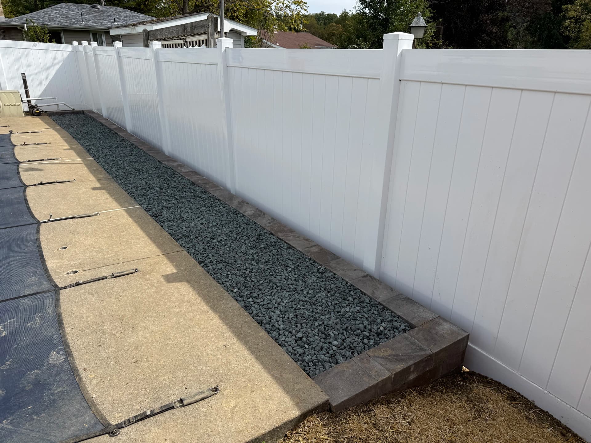 Gallery photos for 6-Foot White Vinyl Privacy Fence with Retaining Wall and Decorative Stone: Image #1