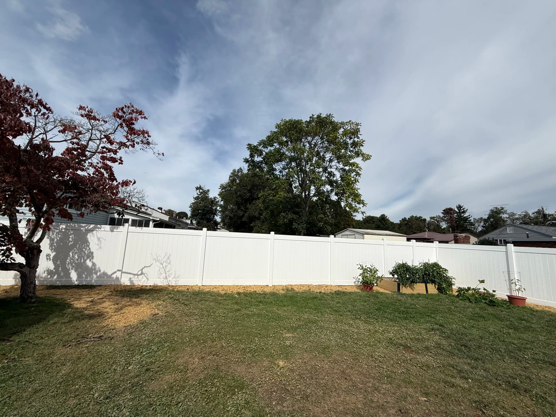 Gallery photos for 6-Foot White Vinyl Privacy Fence with Retaining Wall and Decorative Stone: Image #6